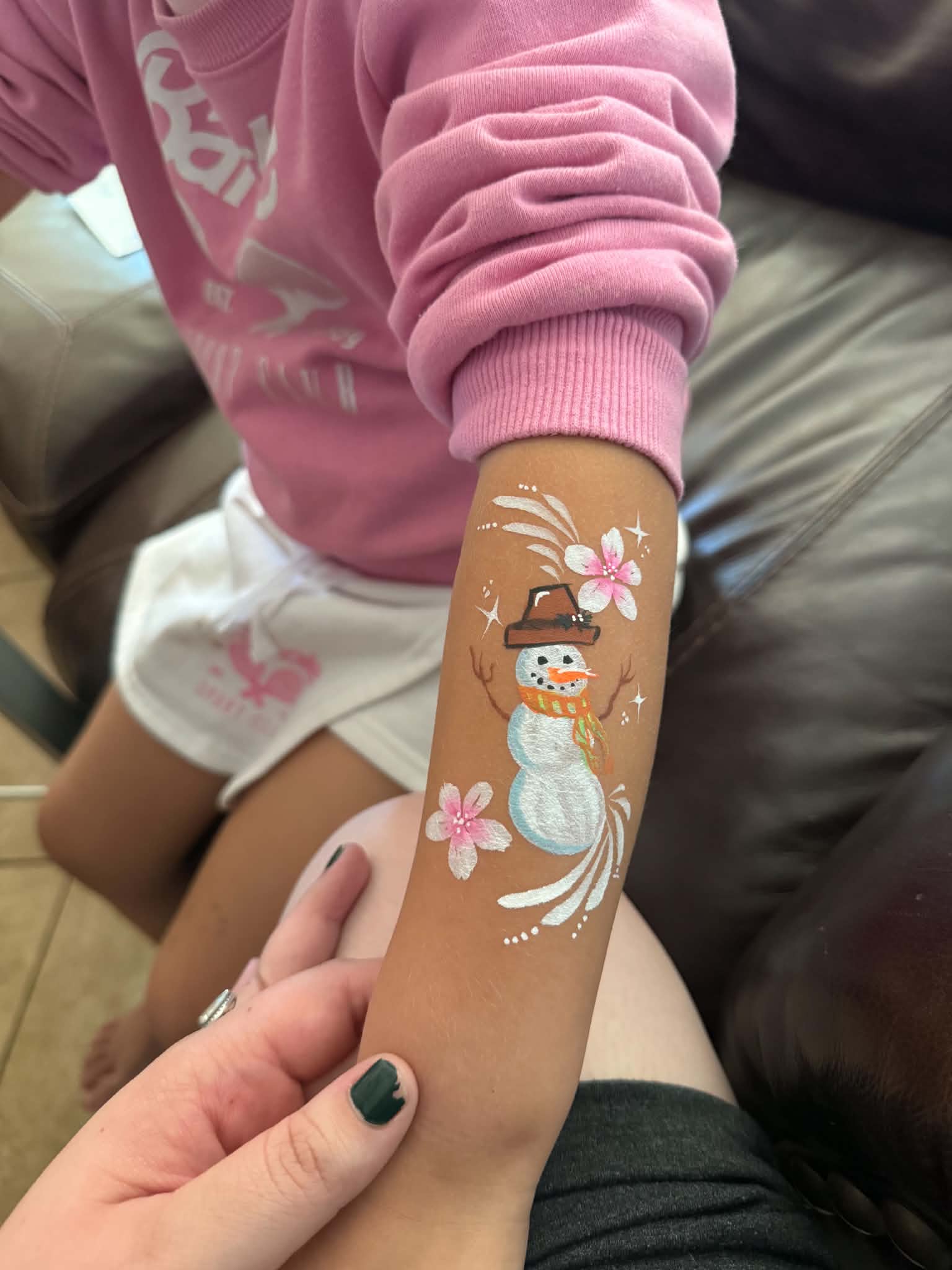 Snowman arm painting at a holiday celebration