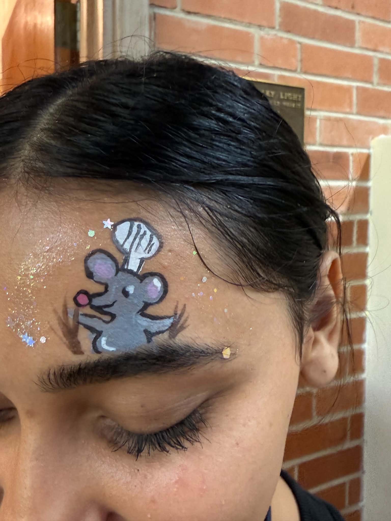 Chef rat character face painting at a community outreach event