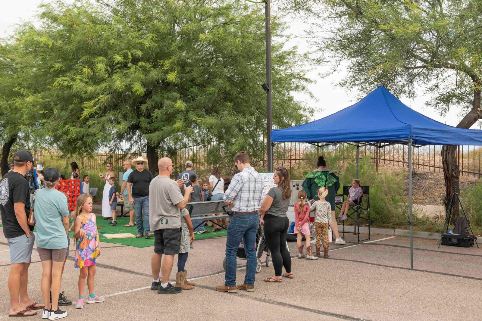 Families lined up at the Sparkle & Smudge tent during a Tucson community event