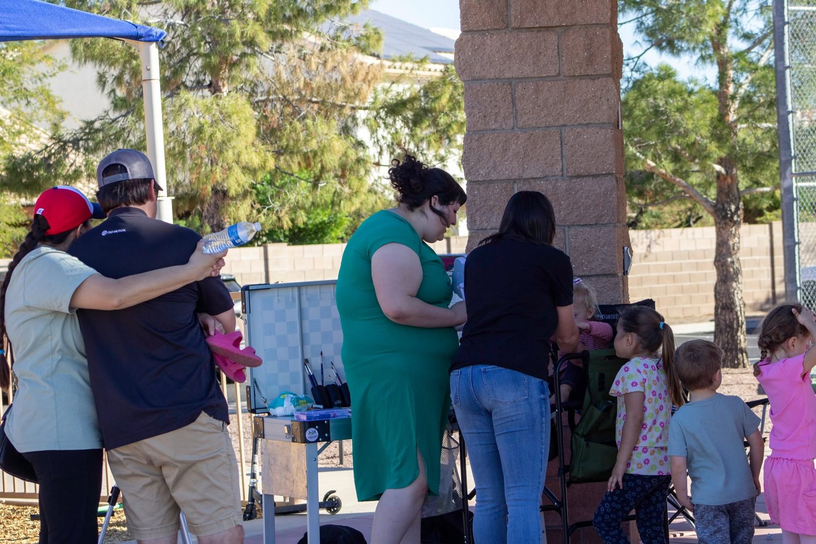 Kids waiting their turn for face painting at a birthday party