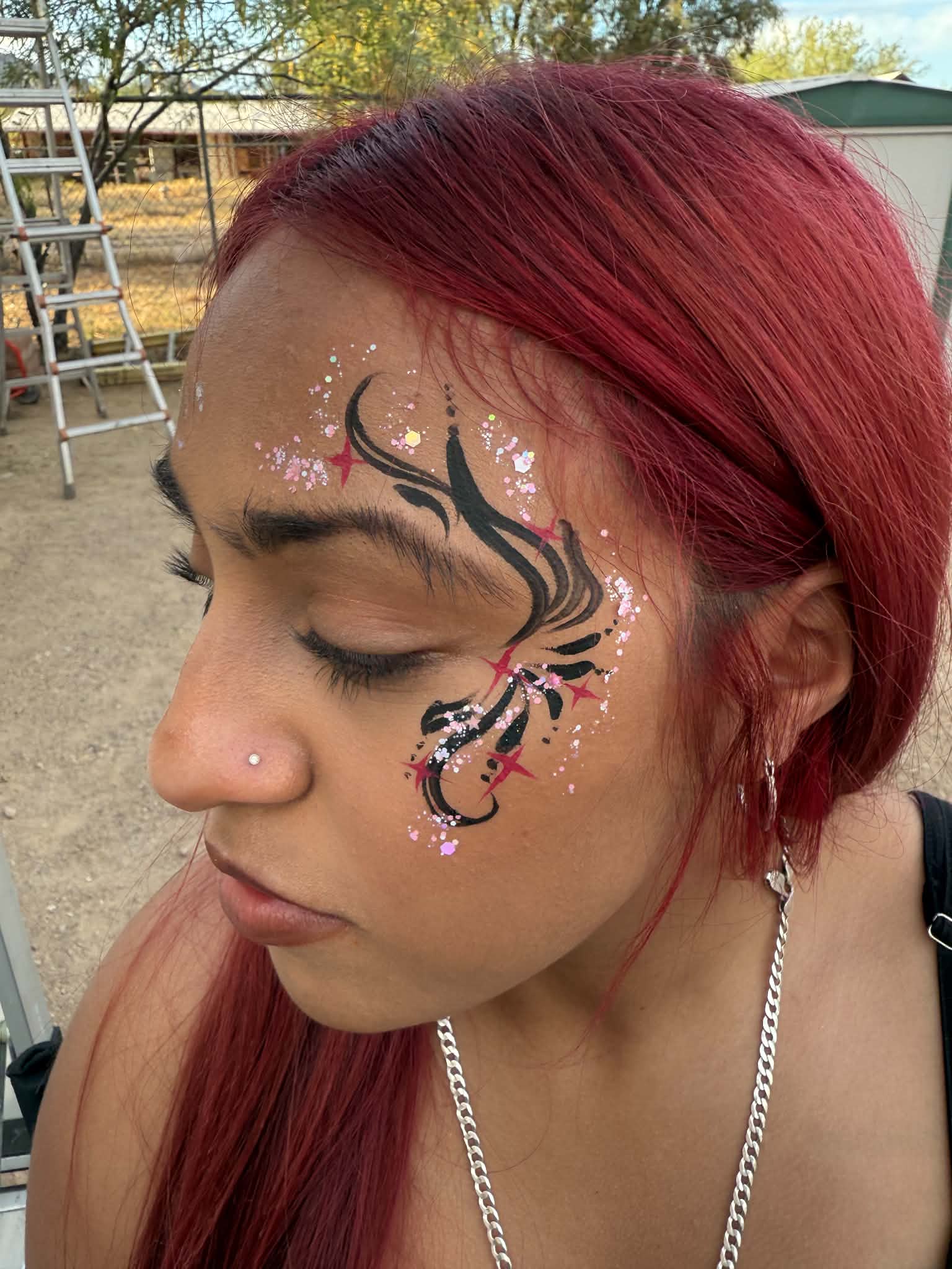 Detailed black and gold face painting