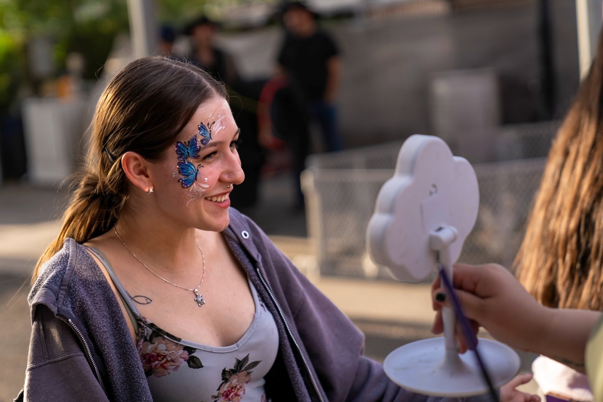 Purple butterfly face painting at a birthday celebration