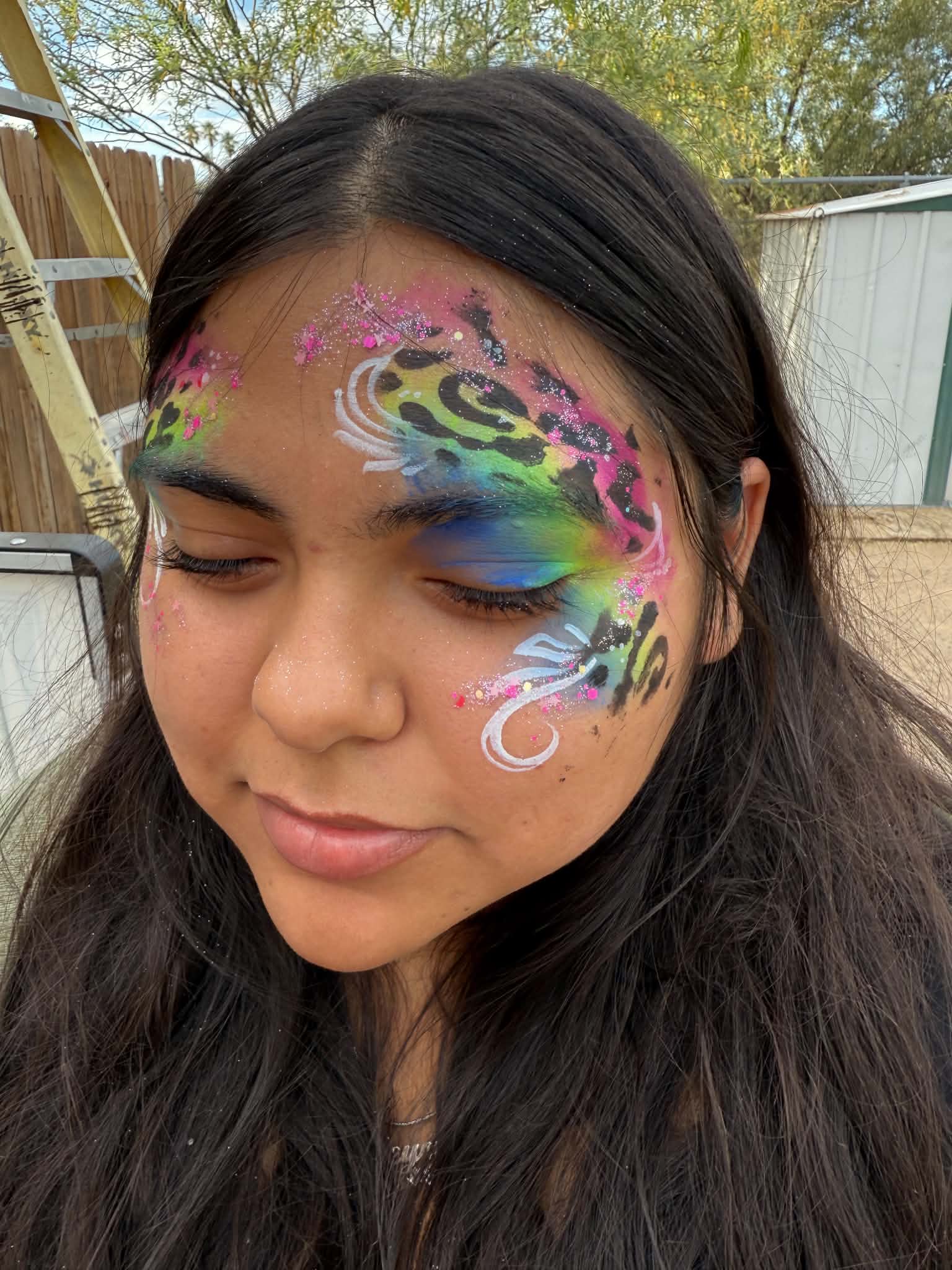 Rainbow leopard-print face paint